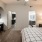 a bedroom with a bed and a mirror