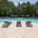 a pool with chairs and umbrellas