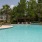 a swimming pool with a house in the background