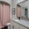 a bathroom with a pink shower curtain