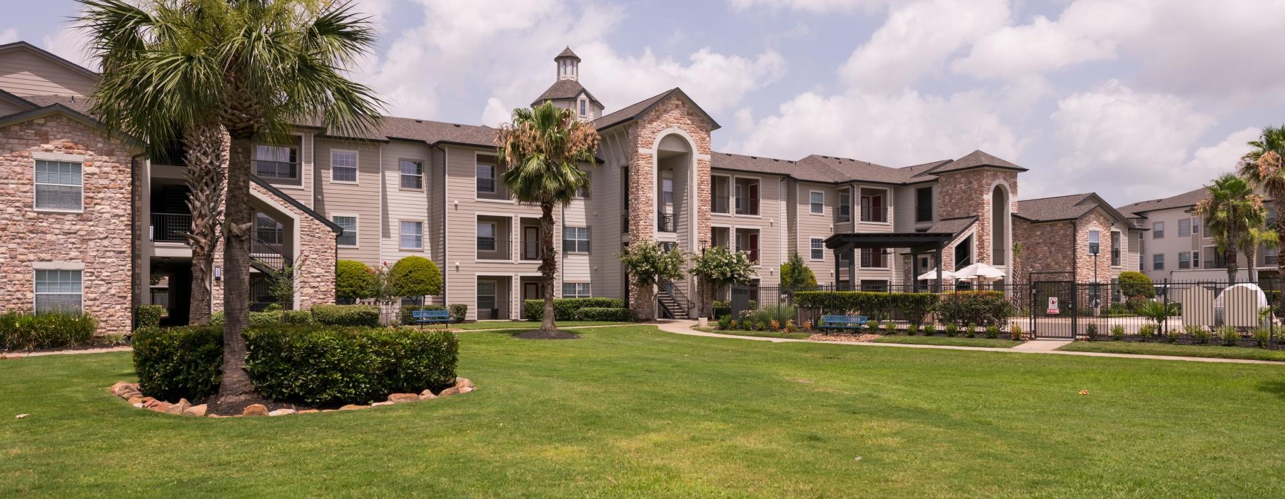 a large building with palm trees