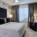 a bedroom with a bed and a mirror